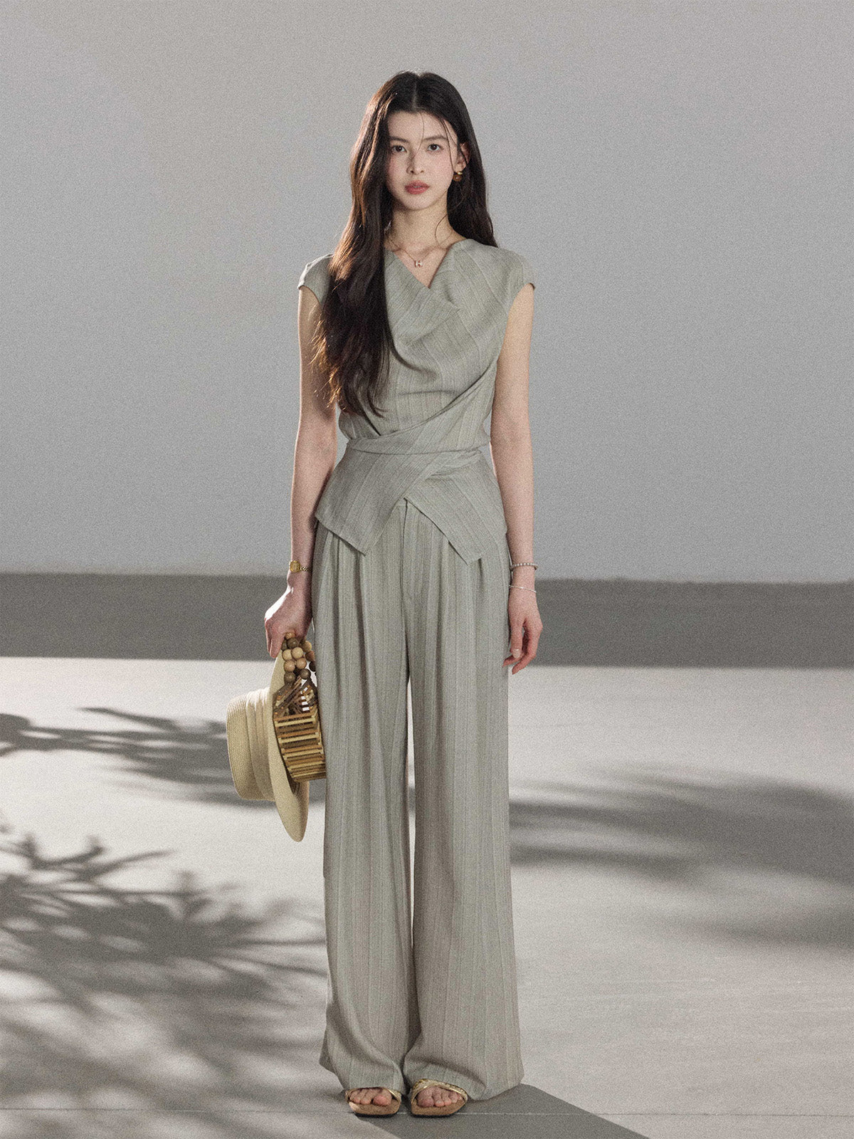 Full-length wide-leg pants in light grey with vertical stripes.