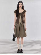 Back view of brown puff sleeve top with side ties.