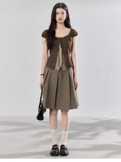 Back view of brown puff sleeve top with side ties.
