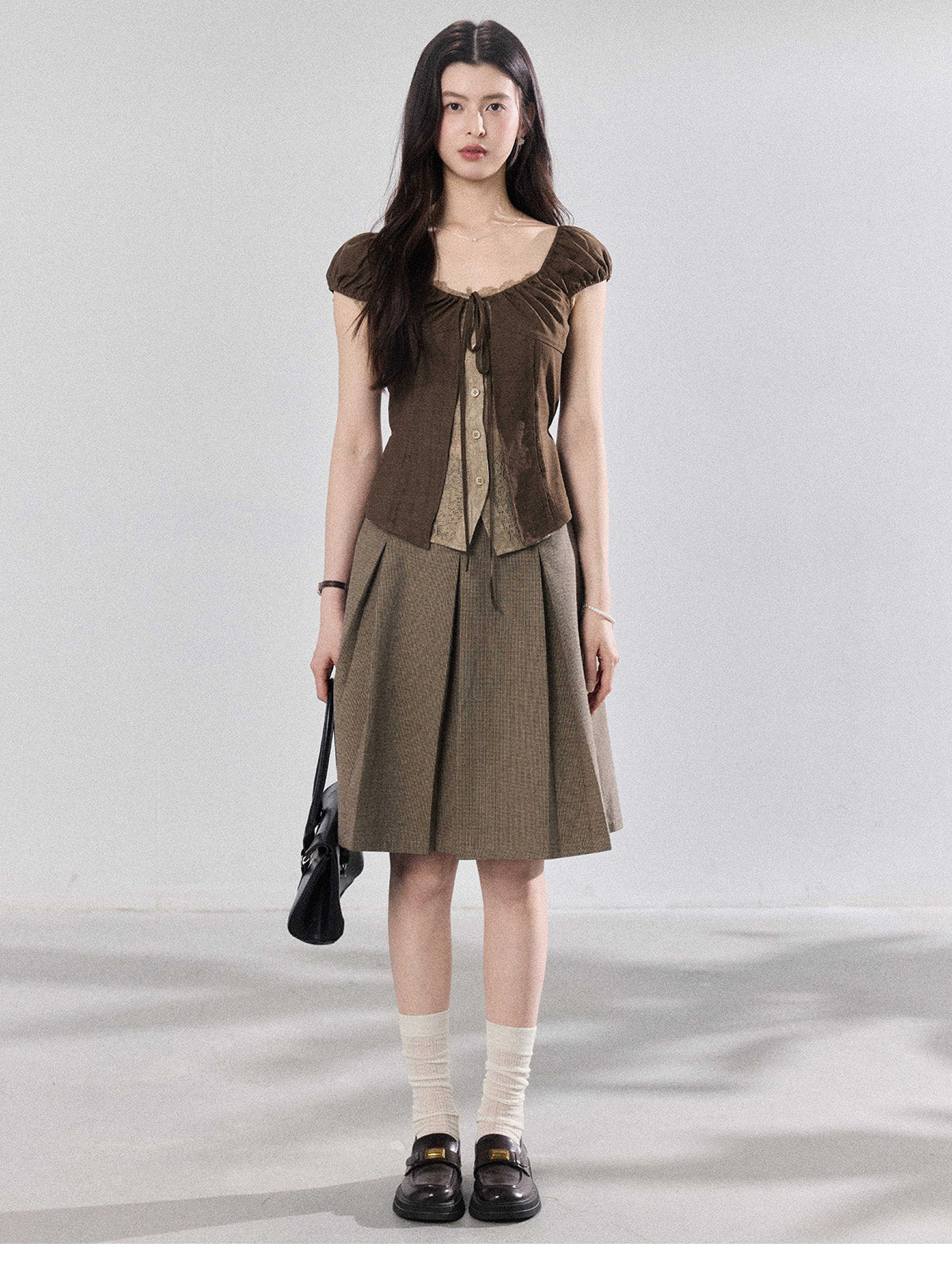 Back view of brown puff sleeve top with side ties.