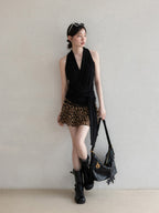 Close-up of black halter top showing gathered neckline