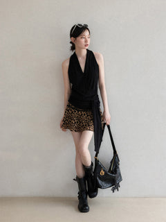 Close-up of black halter top showing gathered neckline