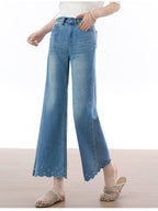 Close-up of front pockets and button fly on light blue flared jeans.