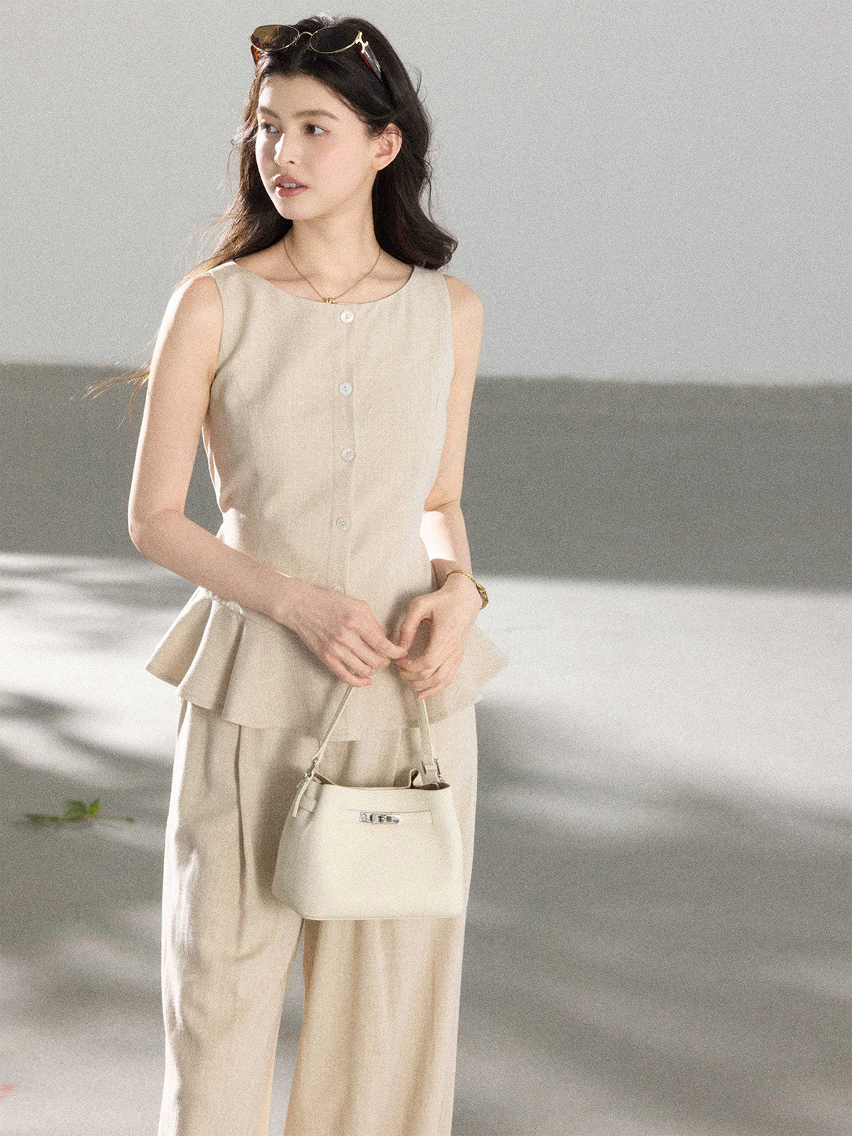Beige wide-leg pants with pleats at the front of the waist