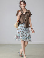 Light blue polka dot A-line skirt with tiered ruffles and high waist.