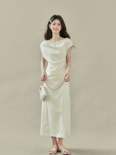 Back view of cream off-shoulder dress with short sleeves and V-neckline.