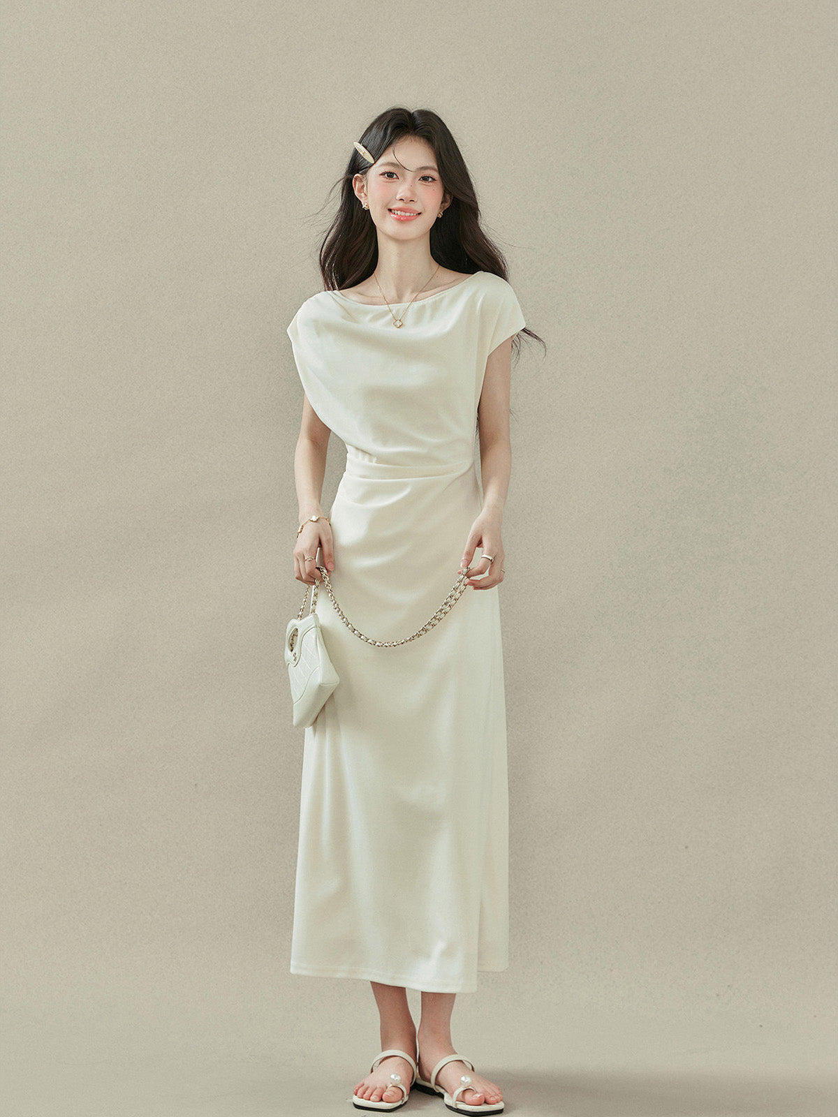 Back view of cream off-shoulder dress with short sleeves and V-neckline.