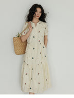 Short-sleeved A-line dress with floral embroidery on the bodice.