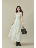 Ivory sleeveless dress with a square neckline, thin straps, and side seam darts.
