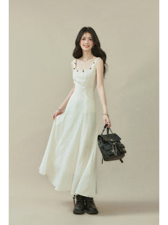 Ivory sleeveless dress with a square neckline, thin straps, and side seam darts.