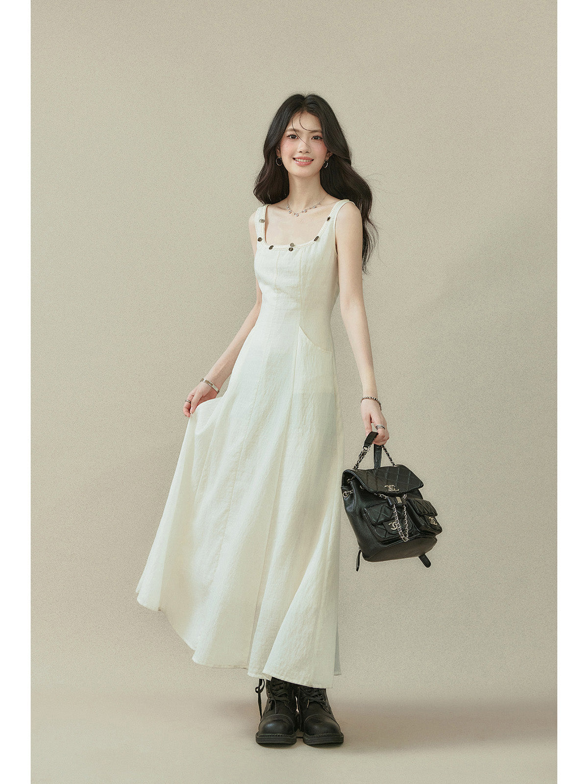 Ivory sleeveless dress with a square neckline, thin straps, and side seam darts.
