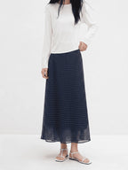 Navy polka dot A-line midi skirt with elastic waistband and flared hem.