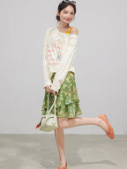 Green floral A-line skirt featuring layered ruffles and a ruffled hem.