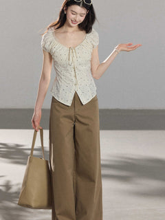 Side view of khaki wide-leg pants with front pockets and high-rise waist