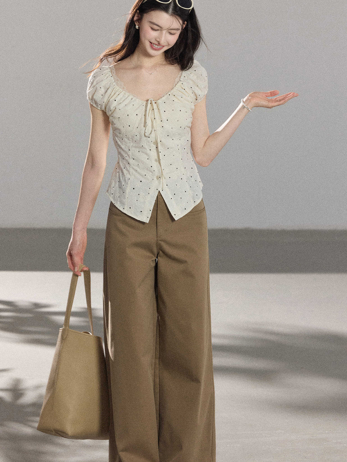 Side view of khaki wide-leg pants with front pockets and high-rise waist