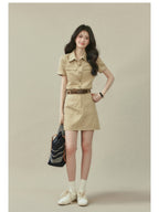 Beige collared shirt dress featuring two chest pockets and a straight hem.