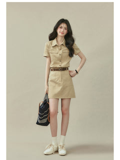 Beige collared shirt dress featuring two chest pockets and a straight hem.