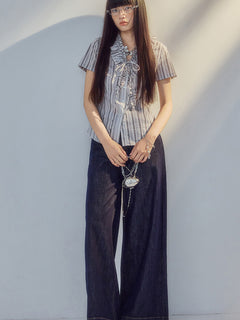 Short-sleeved blouse with ruched waist and tie detail.