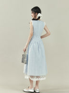 Light blue dress with vertical stripes, lace trim on the shoulders and hem, a bow tie neckline, and an A-line silhouette.