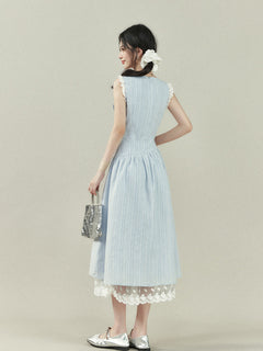 Light blue dress with vertical stripes, lace trim on the shoulders and hem, a bow tie neckline, and an A-line silhouette.