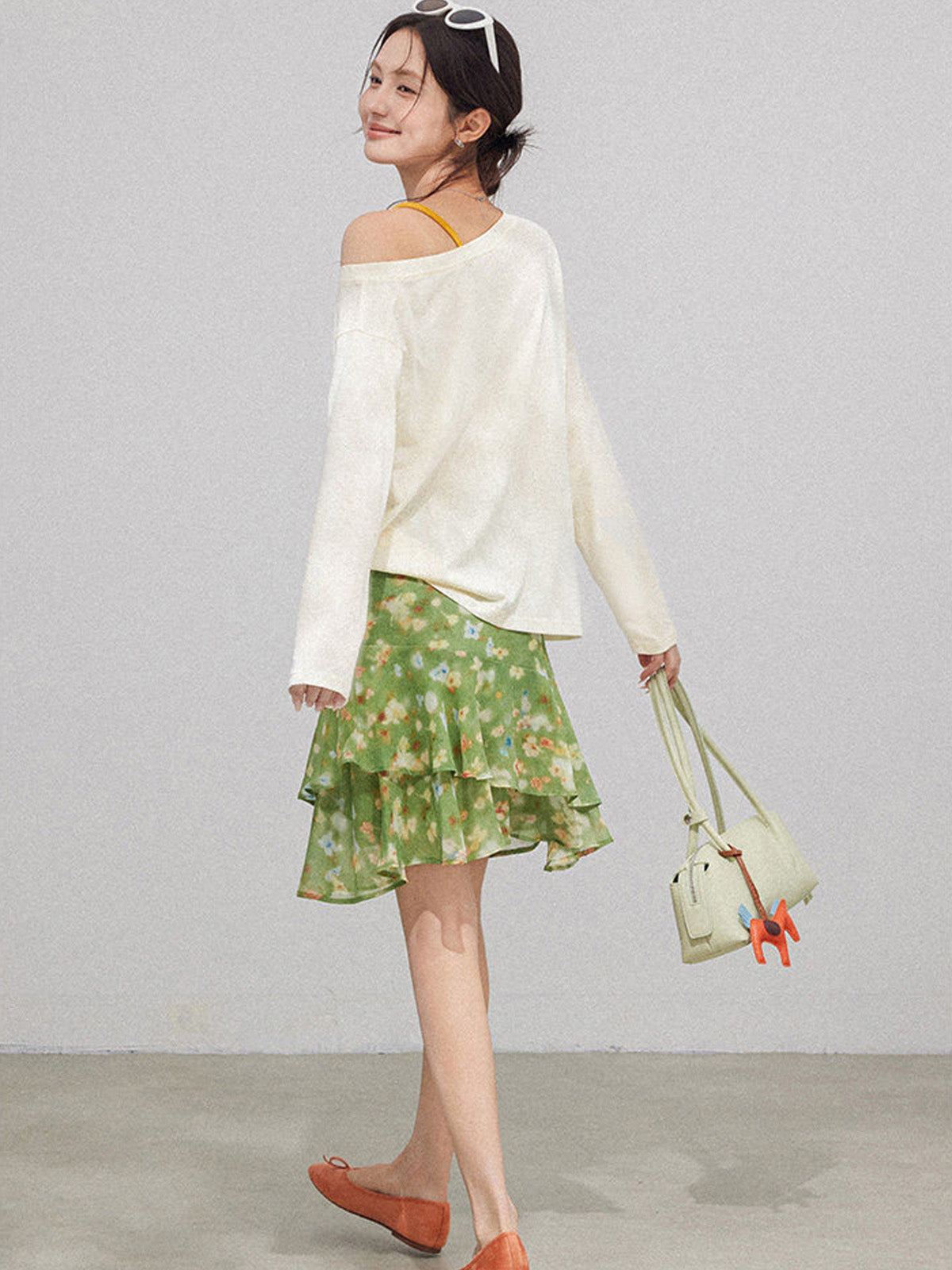 High waist green floral skirt with multiple ruffled layers.