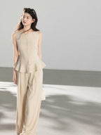 Beige high-rise wide-leg pants shown from the back with a straight hem