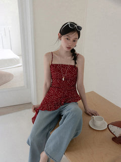Red floral tank top shown from front, highlighting asymmetrical hemline.