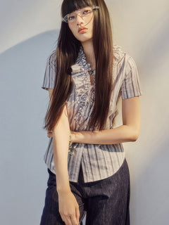 V-neck blouse with ruffled trim and button placket closure.