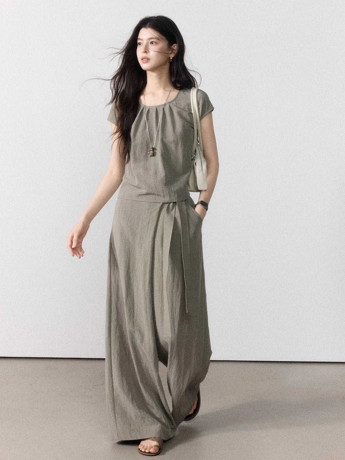 Taupe grey wide-leg pants with a straight hem, shown from the front.
