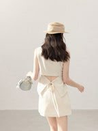 Ivory a-line tank top with high waist and woven tie at back.