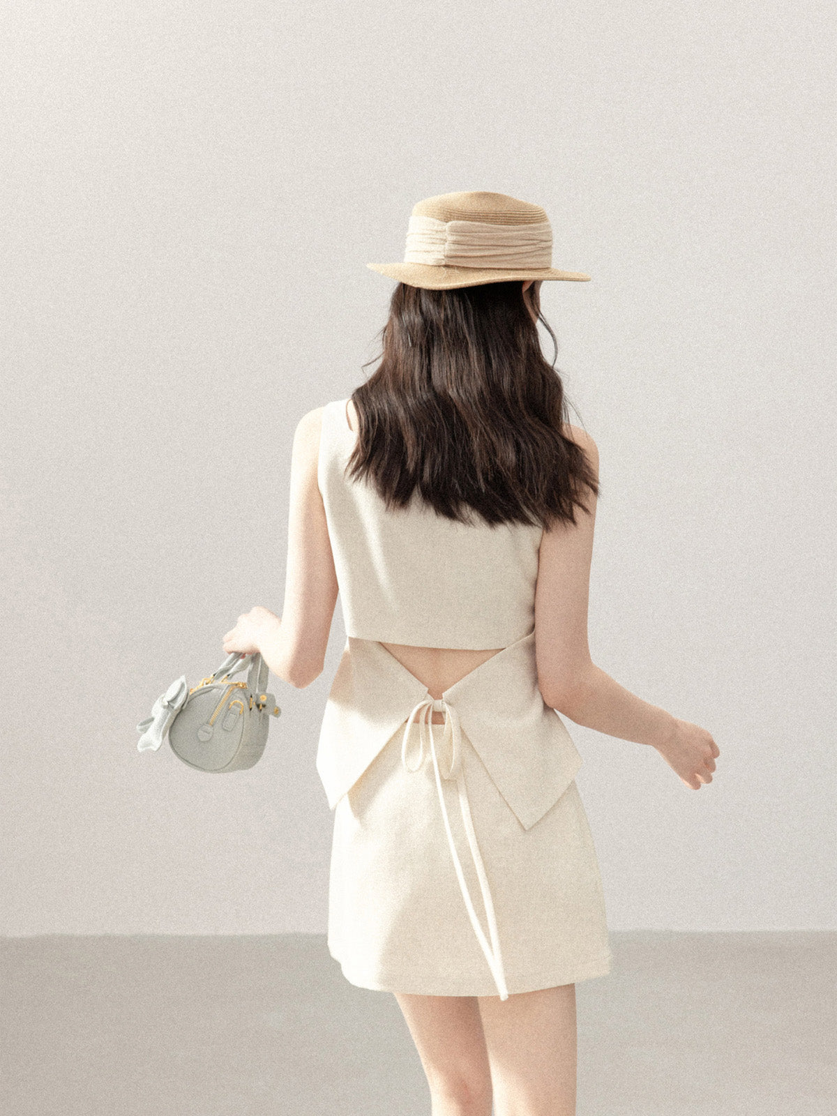Ivory a-line tank top with high waist and woven tie at back.