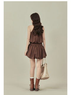 Back view of brown A-line dress showing pleated skirt and belt.