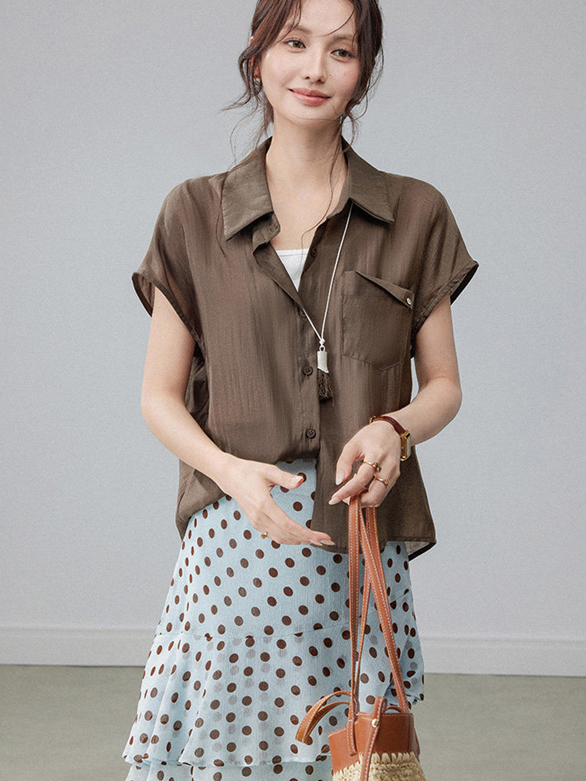 Polka dot light blue skirt with layered ruffles and a high waist.