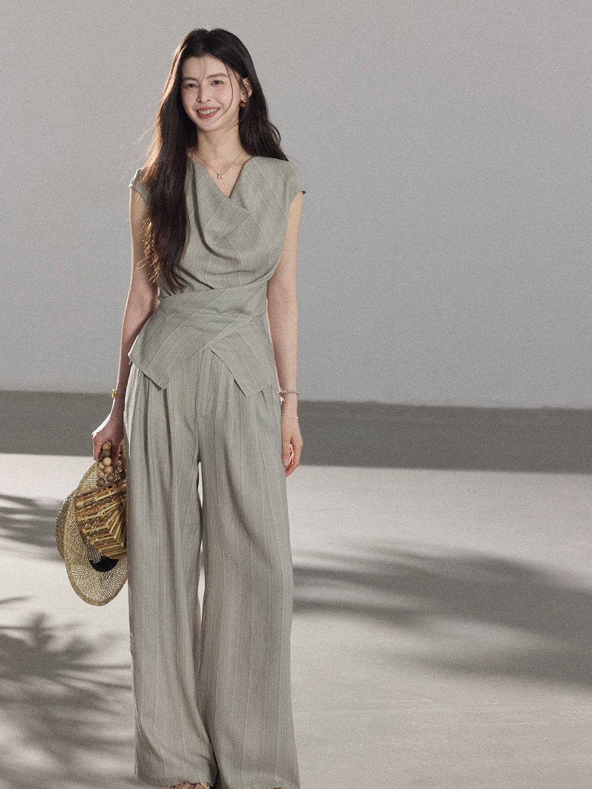 Light grey pants with a tied waist belt and side pockets.