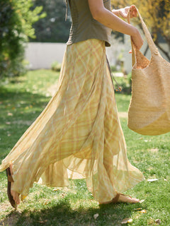 Yellow plaid a-line skirt worn with green top outdoors
