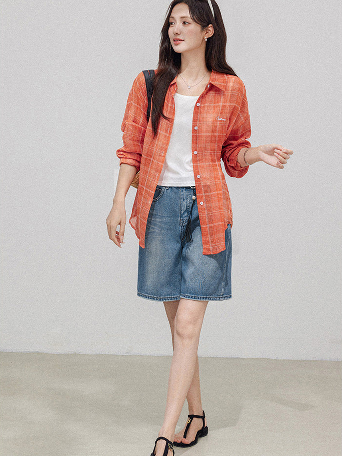 High rise a-line denim shorts with tassel accessory.