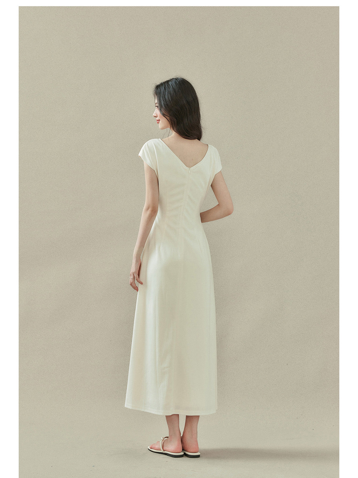 Cream off-shoulder dress with short sleeves, draped neckline, and side slit.