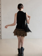 Close-up of black halter top highlighting asymmetric hem and wrap detail