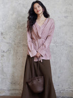 Coffee brown A-line skirt shown from the side, highlighting asymmetrical seam.