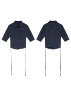 A navy striped fitted top with a collar, button-front closure, cuffed sleeves, and side ties.