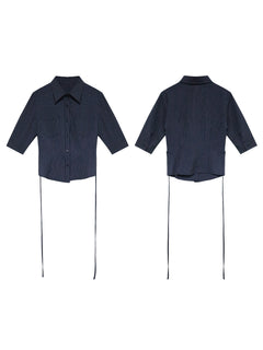 A navy striped fitted top with a collar, button-front closure, cuffed sleeves, and side ties.