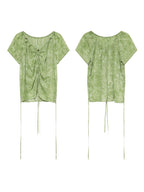 A flat lay shows a green tie-dye top from the front and back, highlighting its ruched design.