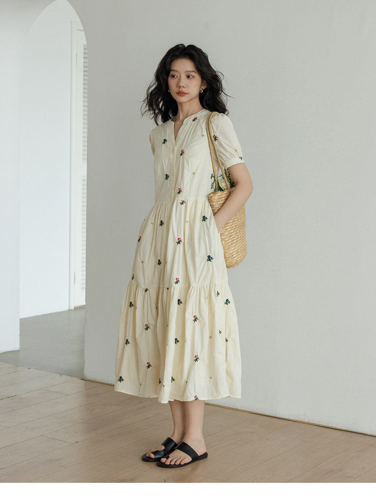 Tiered skirt dress with gathered waist and floral details.
