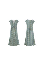 Front and back views of a long, light blue dress with a green leaf pattern.