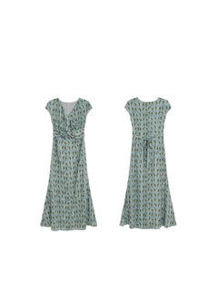 Front and back views of a long, light blue dress with a green leaf pattern.