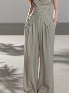 Vertical striped wide-leg pants in light grey, high-rise style.