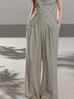 Vertical striped wide-leg pants in light grey, high-rise style.