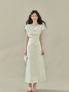 Front view of cream off-shoulder dress with short sleeves and gathered waist.