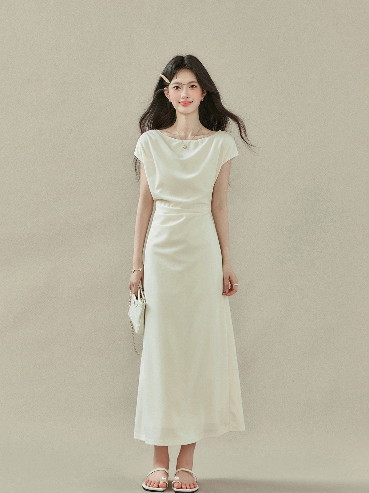Front view of cream off-shoulder dress with short sleeves and gathered waist.