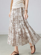 Beige paisley patterned midi skirt with elastic waist and flared hem.